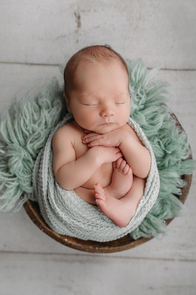 baby boy wrapped in sage green for tampa newborn photography session