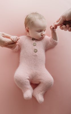 newborn baby girl holding mom and dad's fingers during tampa newborn photographer sesison