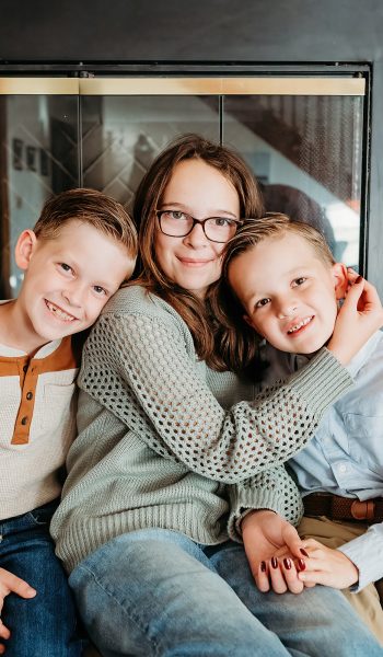 family of five poses outdoors on their family property for tampa family photographer