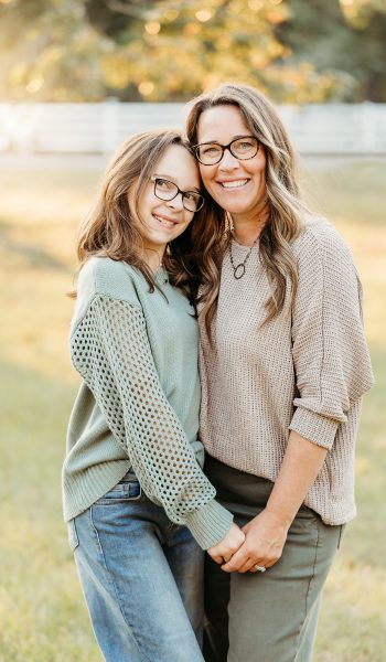 family of five poses outdoors on their family property for tampa family photographer