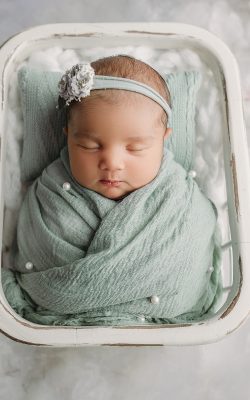 tampa newborn photography Newborn wrapped in soft green fabric for tampa newborn photos