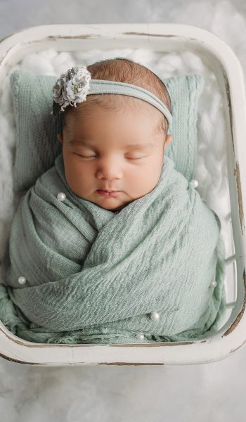 tampa newborn photography Newborn wrapped in soft green fabric for tampa newborn photos